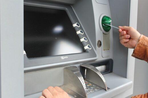 a person using an ATM
