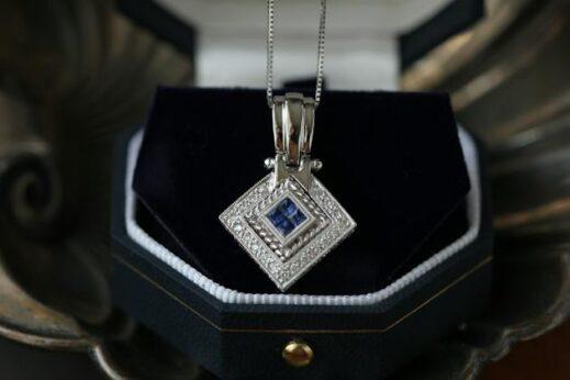 a gaudy necklace with a diamond-shaped jewel in the center