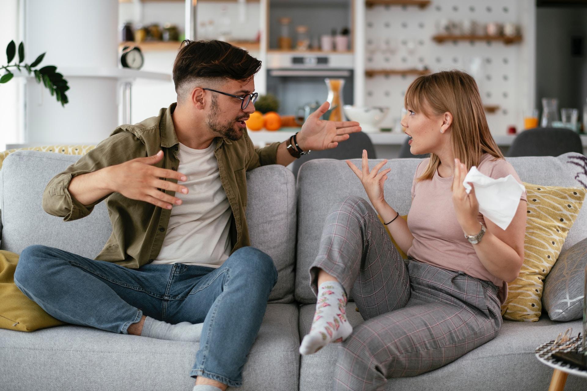 two people arguing on a couch