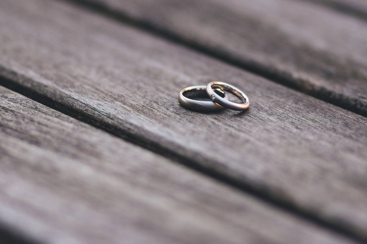 two rings resting on a wooden surface