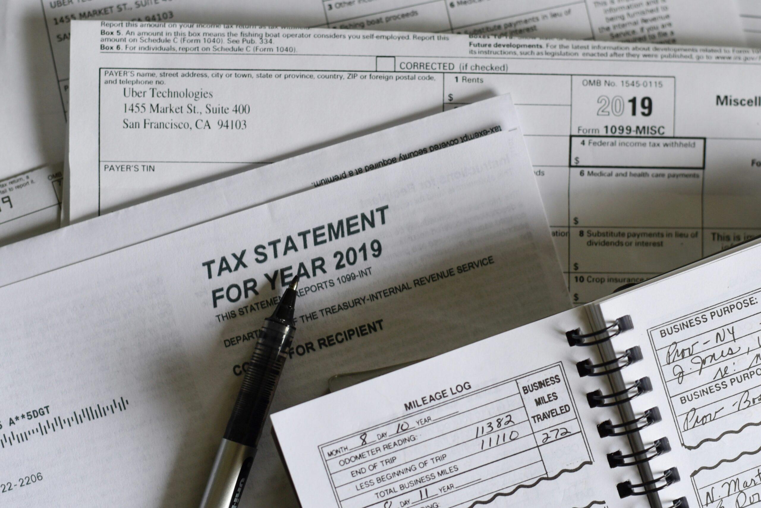 Tax forms and a calculator arranged on a desk, symbolizing tax preparation and financial planning.